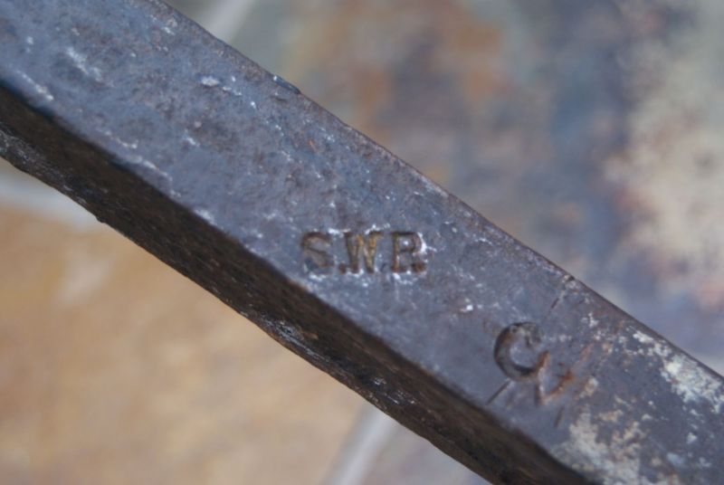 'S.W.R.' stamped in the axle of the wooden-wheeled station barrow.