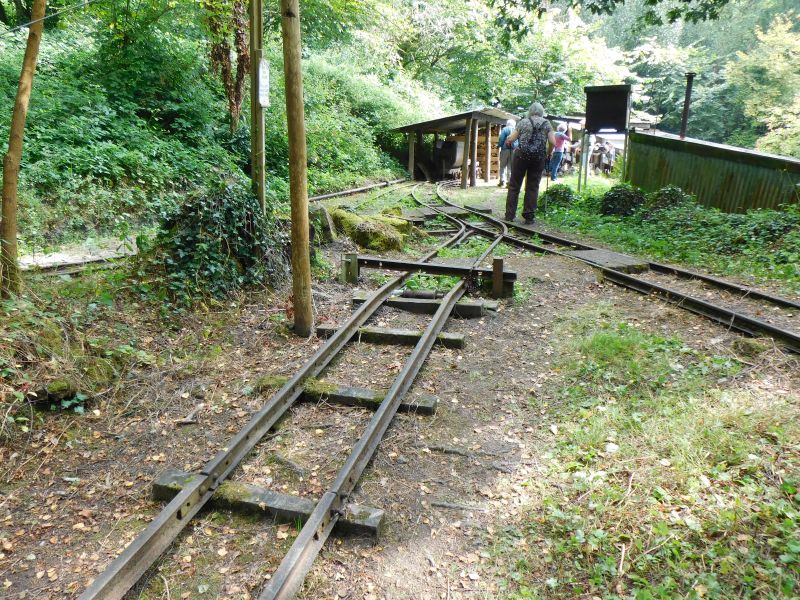 Part of the 18 inch gauge rail network. Central track is the top of the rope worked incline, which descends to the adit behind the photographer. Right track is a waste tip siding. Left track is a branch to the head of a vertical shaft to deeper levels.brPhotographer Jon KelseybrDate taken 01092024